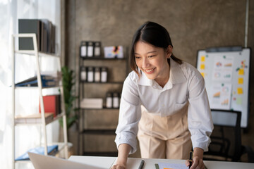 Portrait of an Asian young business Female working on a laptop computer in her workstation.Business people employee freelance online report marketing e-commerce telemarketing concept.