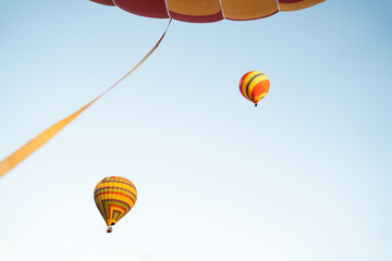 Fototapeta premium Aerial view of the sunrise at the city with a Hot Air Balloon at Vang Vieng Laos. Adventure concept. Tourism in Vang Vieng, Laos.