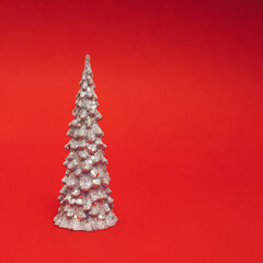 Christmas or New Year layout with white glittering Christmas tree on a red background. Bright Holiday composition.