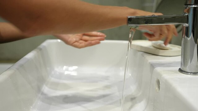 Close-up Cropped Shot Of Unrecognizable Young Woman Washing Hands With Soap And Hot Water At Home Bathroom Sink For Help Fight Bacteria And Germs. Concept Of Healthy Lifestyle. Shooting In Slow Motion