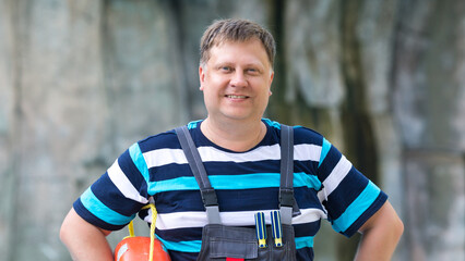 Fototapeta premium Portrait of an adult man with a lifebuoy near the water.