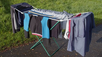 drying rack full with clothing standing in garden