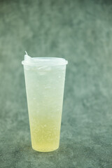 Iced soda lemon in a long plastic glass