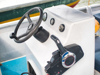 A boat steering wheel and lever with instrument panel