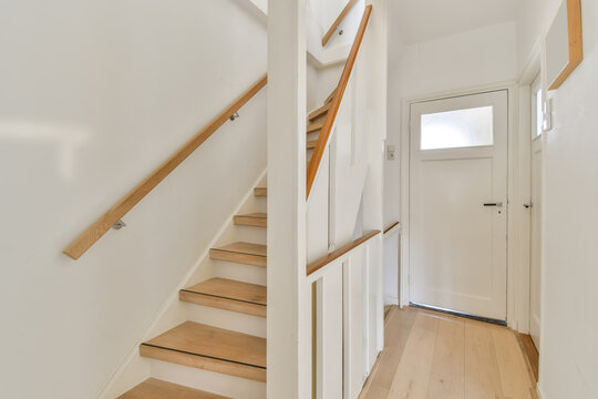 Light hallway with white staircase