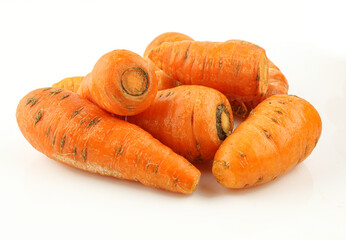 Pile of small organic homegrown carrots isolated on white background