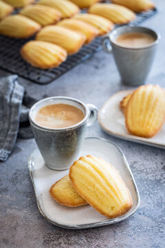 Freshly baked madeleines with a cup of coffee