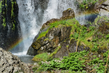 Fototapeta na wymiar Rainbow on Shakinsky waterfall, which is 18 meters high. It is located in the Syunik region of Armenia, near the city of Goris.