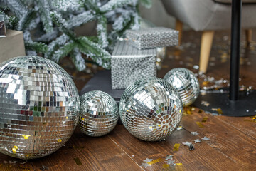 Christmas and New Year background. Mirror balls and gifts near Christmas tree in room. Horizontal