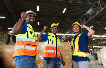 Indian male and female workers raising hands to show appreciation Loading packaging boxes at the warehouse port