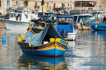 malta colorful painted fishing boat in marsaxlokk village