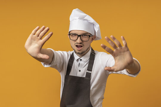 the cook extended both palms forward, urging them to stop. concept do not enter. - Powered by Adobe