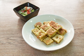 fried chicken  Murtabak roti stuffed chicken on plate dipping sweet pickled cucumber sauce