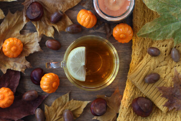 A cup of tea with a slice of lemon. Transparent cup of green tea on a wooden background. View from above.