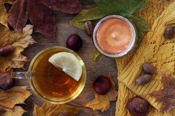 A cup of tea with a slice of lemon. Transparent cup of green tea on a wooden background. View from above.