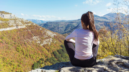 Woman sitting high  in the autumn  mountain with stunning panoramic  view . Balkan mountains,  ,Bulgaria