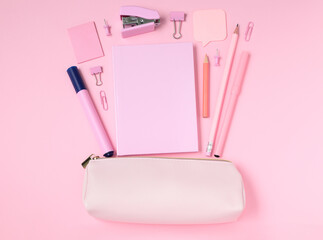 School and office supplies with pencil case on pink background, monochrome concept, mock-up top view