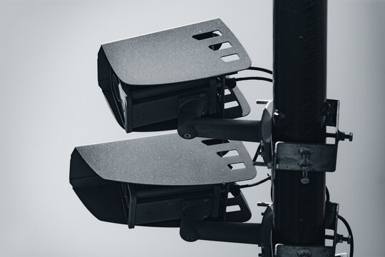 Two radar security cameras installed on a pillar to ensure traffic safety by taking pictures on car license plates