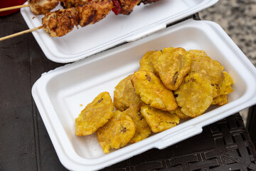 Close up shot of a serving of tostones, a typical Dominican dish made of deep fried plantains,...