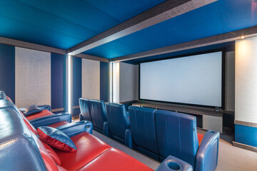 Private home theater in gray-blue tones. A wide screen and two rows of comfortable chairs.