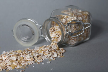 glass can of oatmeal isolated on gray background