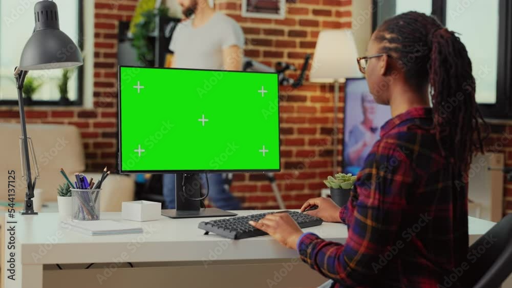 Poster african american person using monitor to check with greenscreen template on isolated display, lookin
