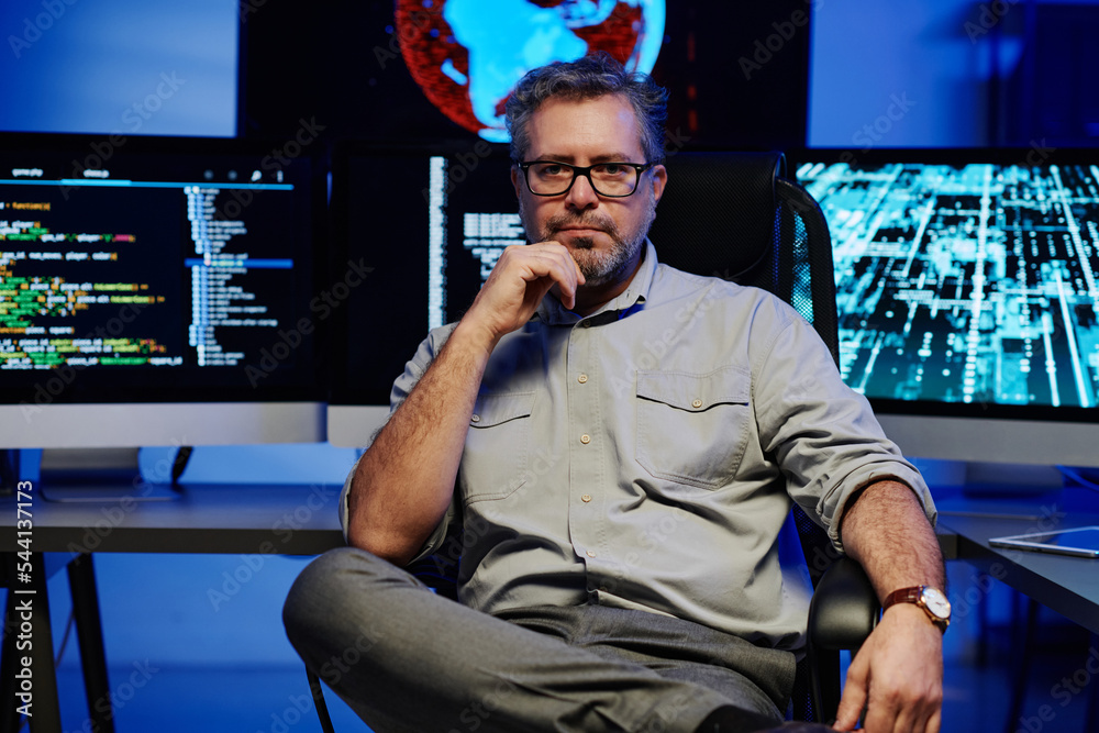 Aufkleber serious mature male software developer in smart casualwear and eyeglasses sitting against computer m