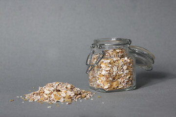 glass can of oatmeal isolated on gray background