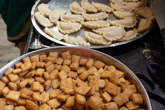 Plates full of crunchy snacks, faral during Diwali Deepawali festival. Shakkar para, shankar pali, gujiya, karanji, deep fried, flour, home made, healthy, cholesterol, indian, maharashtra, crunchy.