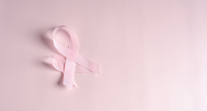 Pink ribbons on colored background, Breast cancer awareness, world cancer day, national cancer survivor day in february concept.