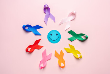 Happy smiley face on center with Multi colorful ribbons, cancer awareness, World cancer day, National cancer survivor day, world autism, supporting people living and illness, Prostate awareness.