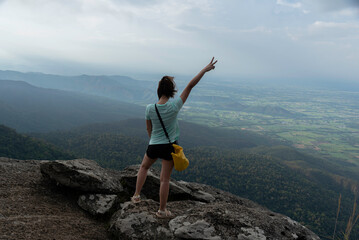 Fototapeta premium Woman travel hiker adventure on mountain nature landscape standing mountain outdoor adventure and leisure travel and relaxing destination in nature park vacation travel
