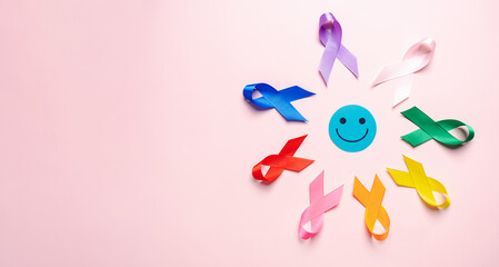 Happy smiley face on center with Multi colorful ribbons, cancer awareness, World cancer day,...