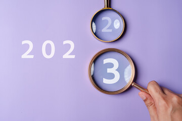 Target business on 2023 year concept. Magnifier focus to 2023 icon. planning project, invest,...