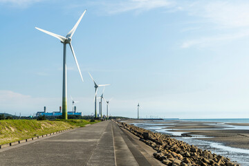 View of wind power systems with blue sky background on the west coast of Taiwan.