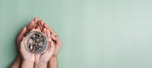 hands of adult and child holding money jar, donation, saving, fundraising charity, family finance...