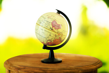 Globe on a wooden table on a blurred background