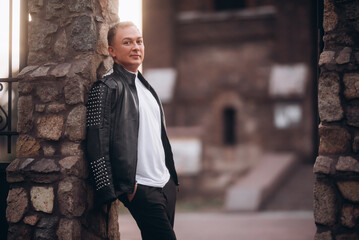 Fototapeta premium Fashion man near old catholic church