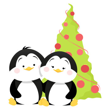 Two cute penguins stand near the Christmas tree