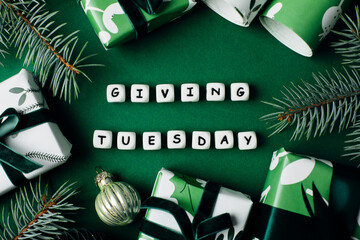 Giving Tuesday concept. Gift Wrapping Boxes, fir tree on green background. Charity, give help, donations support concept. Top view, flat lay - 544155996