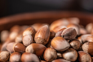 Macro Close up on a pile of hazelnuts with a beautiful depth of field in a brown recipient