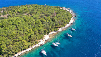 Aerial drone top down photo of sail boats and yachts anchored in traditional fishing village of Fiskardo, Kefalonia island, Ionian, Greece