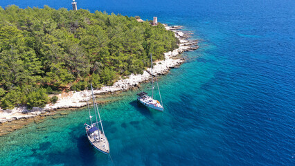 Fototapeta premium Aerial drone photo of luxury sail boat anchored in tropical Caribbean limestone turquoise colour seascape