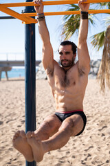 Adult man doing dips on a bar practicing calisthenics exercises. Sports concept.