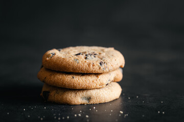 Fototapeta na wymiar Chocolate chip cookies close up on a black background.