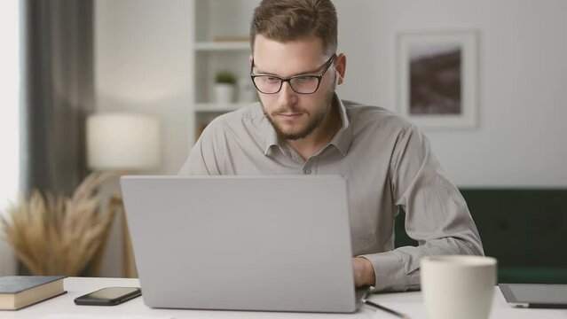 Bearded man working with laptop at home, handsome smart businessman using computer. Multiscene sequence