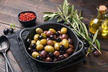 Mixed green olives and black olives with olive oil, healthy eating antioxidants