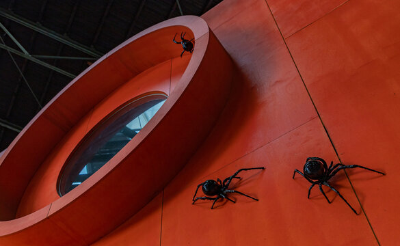 Amsterdam, Netherlands - October 15, 2022: A picture of an art installation with black spiders on display at the NDSM art center.
