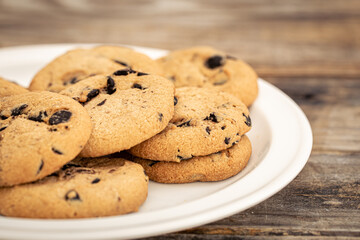 Cookies with chocolate chips close-up on a wooden background.