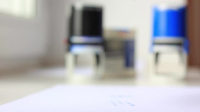 Man's hand puts a stamp seal closeup
